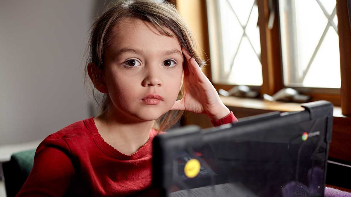 Portrait of fourth grade student looking pensive during e-leaning