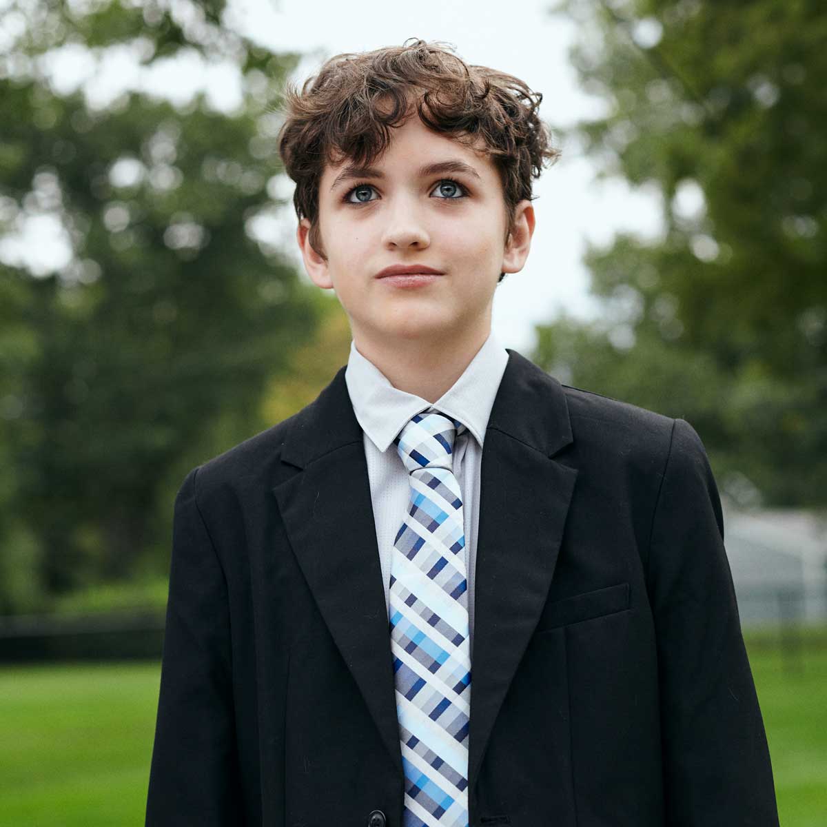 Portrait of high school student dressed in suite and tie for school dance