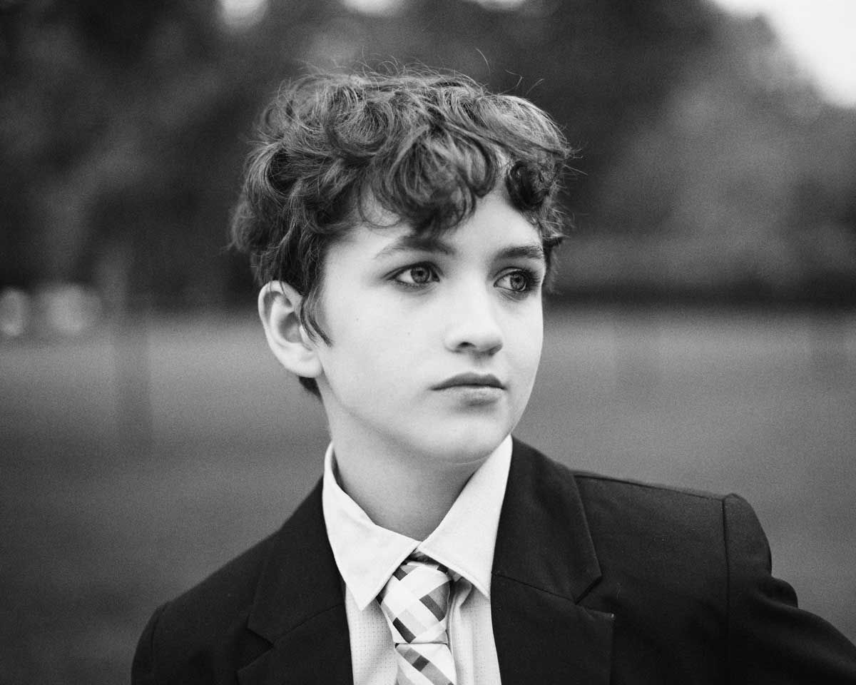 Portrait of high school student dressed in suite and tie for school dance