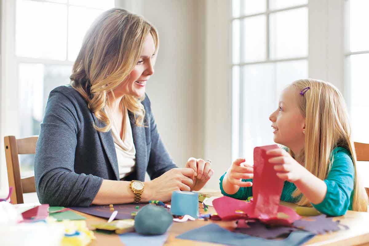 Aspirational photography of a mother and daughter working on crafts at the kitchen table